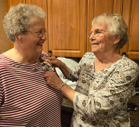 Judith Gregor receives a corsage from Sister Rosemary Bonk