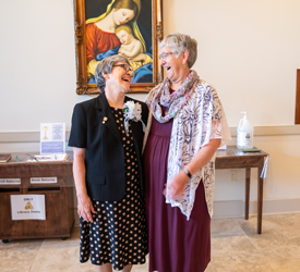 Two sisters share smile and share a moment of happiness during one of the 2024 Jubilee celebrations