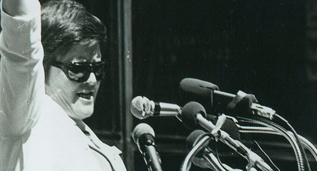 Black and white image of S. Margaret Ellen Traxler talking at a rally 