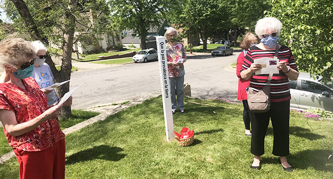 Sisters gather around the Peace Pole at Sister Adaire's home to pray for peace during the race riots in 2020. 