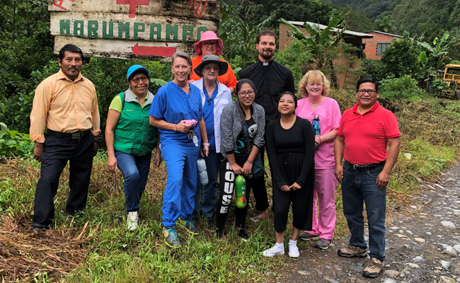 A photo of Carol Toney, a former SSND student and her team in Bolivia. They traveled 8 hours to a village that doesn't get much help from the outside world to provide healthcare. 
