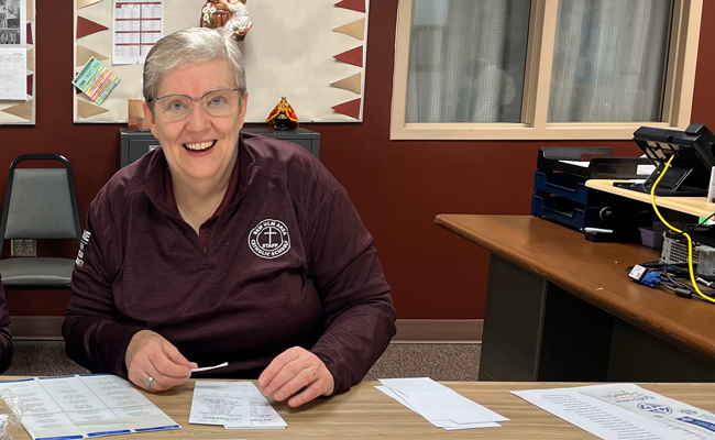 Sister Julie Brandt, president of New Ulm Area Catholic Schools, prepares raffle tickets for a school fundraiser. 