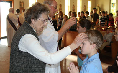 A sister places ashes on a student's forehead during the Ash Wednesday service at St. Martin Church in Milwaukee. 