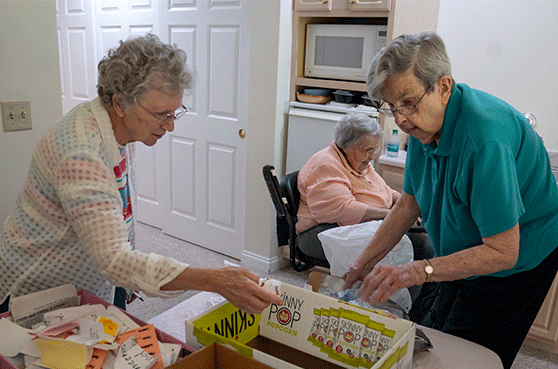 Sisters in action gathering items for recylcing.